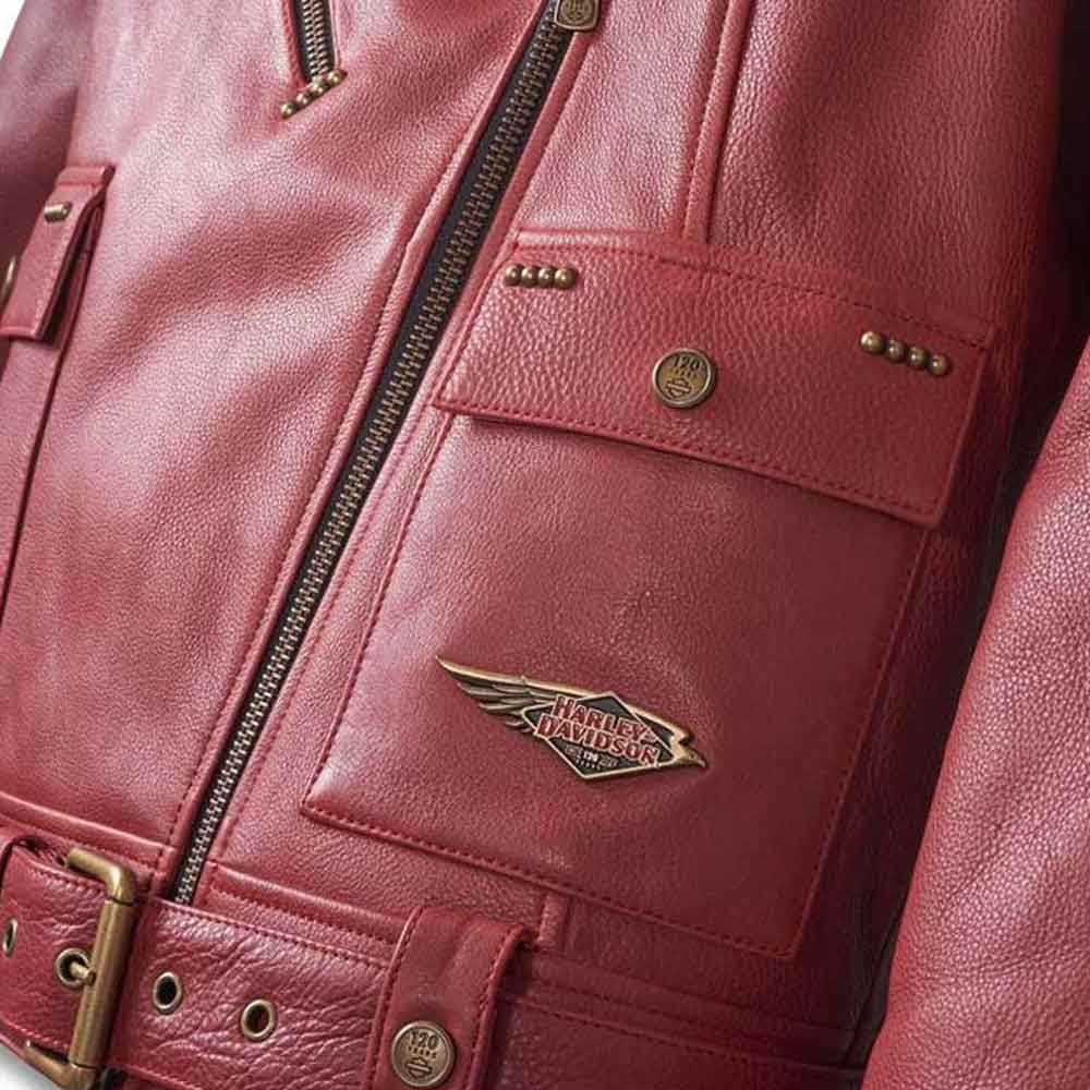 Close-up of a red leather jacket with a brand logo on a dark background