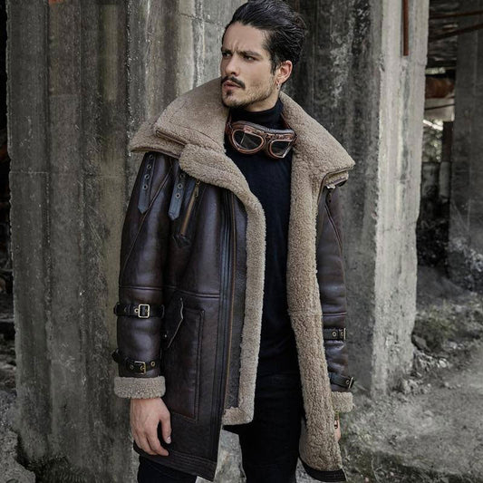 Man wearing a vintage-style leather jacket and shearling coat in an industrial setting