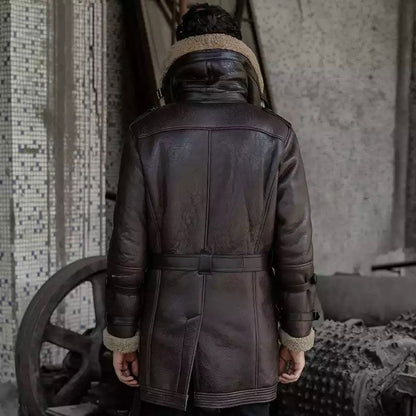 Person wearing a dark leather coat in a rustic indoor setting