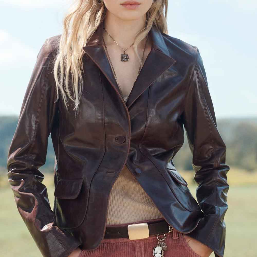 Person wearing a brown leather jacket with a blurred background