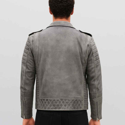 Person wearing a gray leather jacket on a plain background