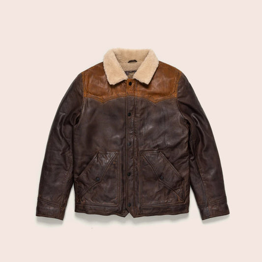 Brown leather jacket with beige shearling collar on a beige background