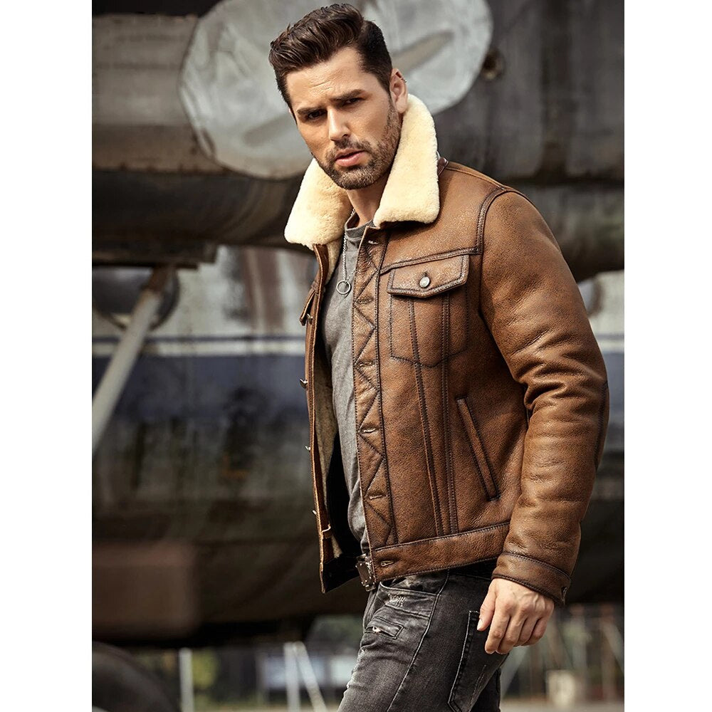 Man wearing a brown leather jacket with a white fur collar in an industrial setting