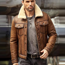 Man wearing a brown leather jacket with shearling lining in an urban setting