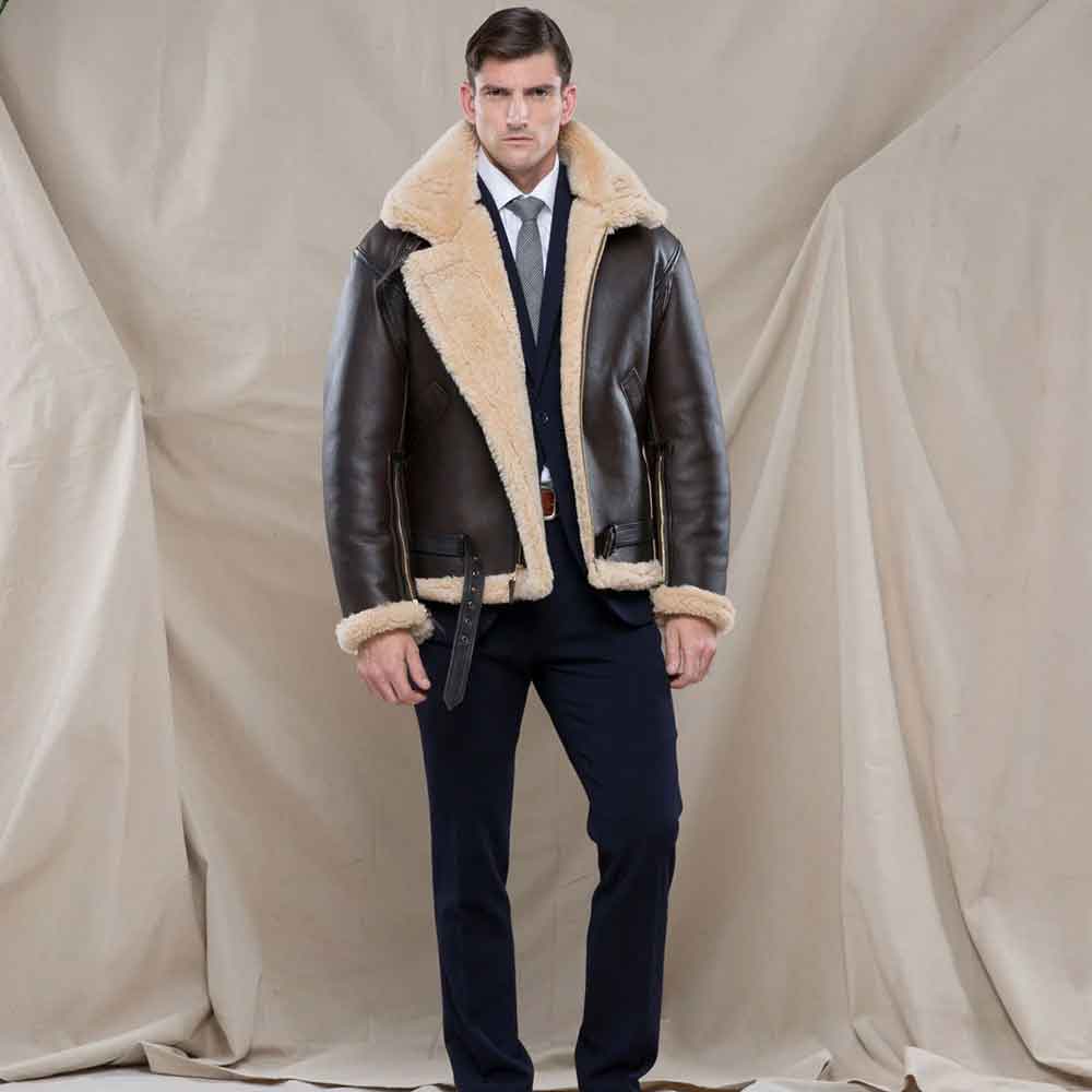 Man wearing a brown leather jacket with fur lining against a plain background