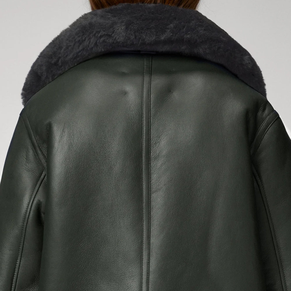 Dark green leather jacket with fur collar on a white background