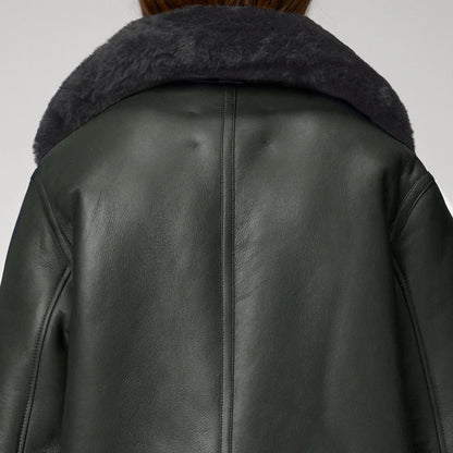 Dark green leather jacket with fur collar on a white background