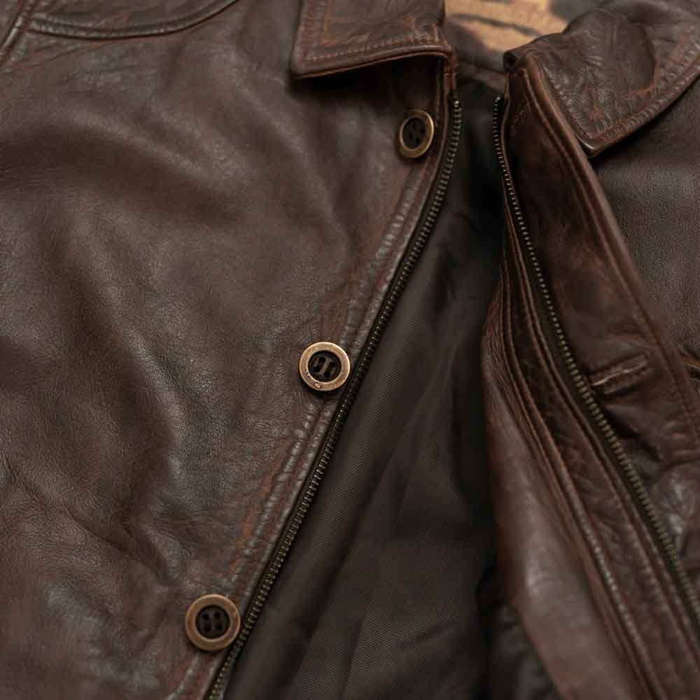 Close-up of a brown leather jacket with buttons and zipper