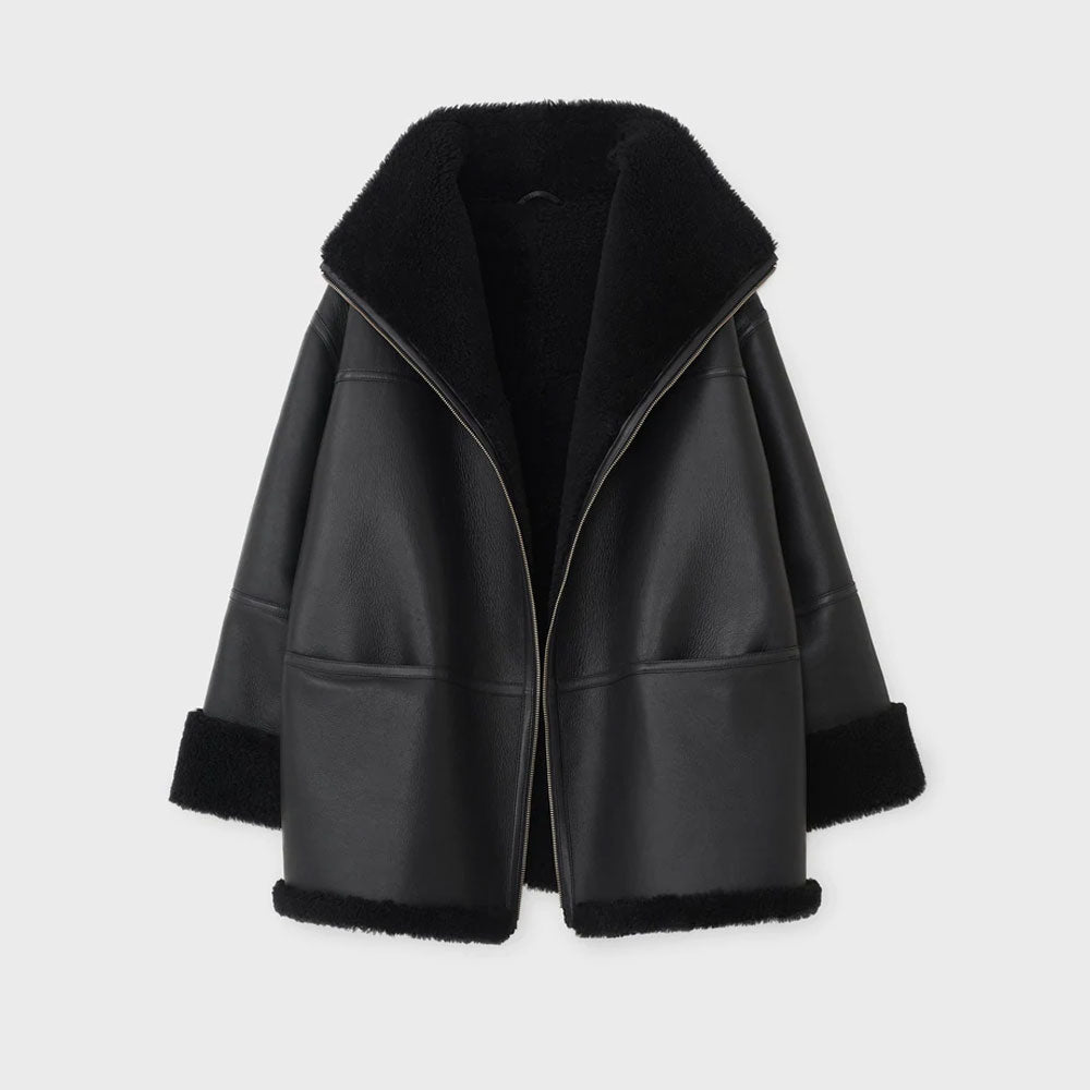 Black leather jacket with fur trim on a light gray background