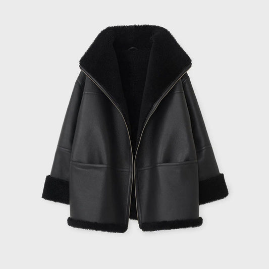 Black leather jacket with fur trim on a light gray background