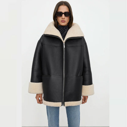 Woman wearing a black leather jacket with white fur trim on a white background