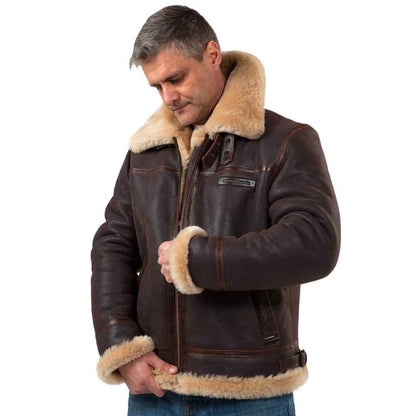 Man wearing a brown leather jacket with beige fur lining on a white background