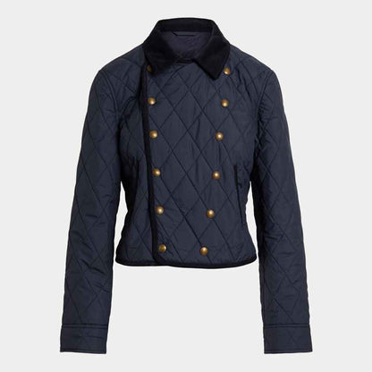 A navy blue quilted cropped jacket with a dark navy collar and double-breasted gold buttons, shown against a light gray background.