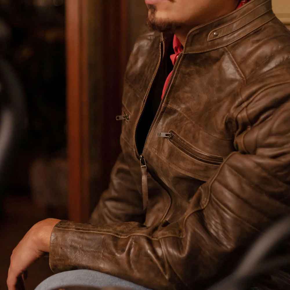 Person wearing a brown leather jacket indoors