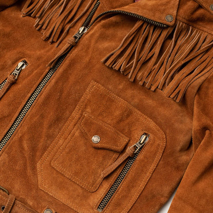 Close-up of a brown suede fringe jacket showing the chest pocket, zipper, and fringed neckline details.