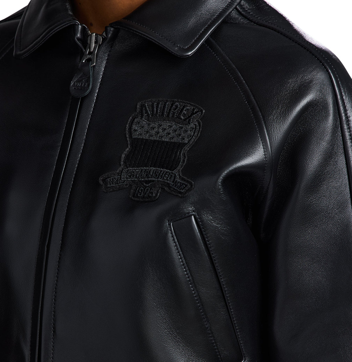 Raglan-style shoulder seams on black Avirex bomber jacket