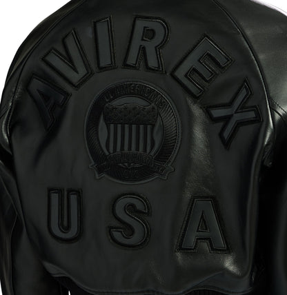 Close-up of black AVIREX and USA leather back lettering