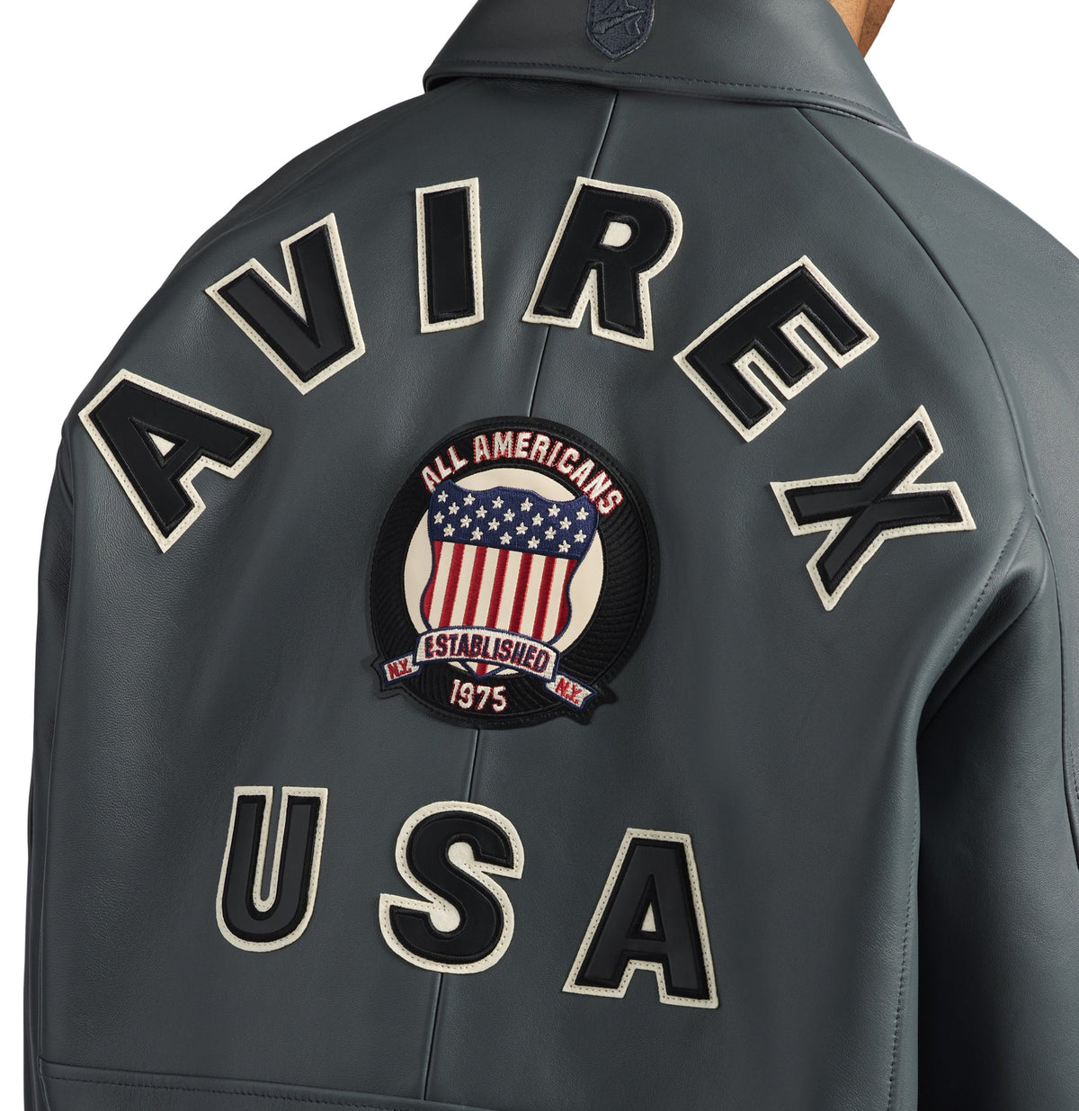 Close-up of AVIREX lettering and embroidered shield on jacket back