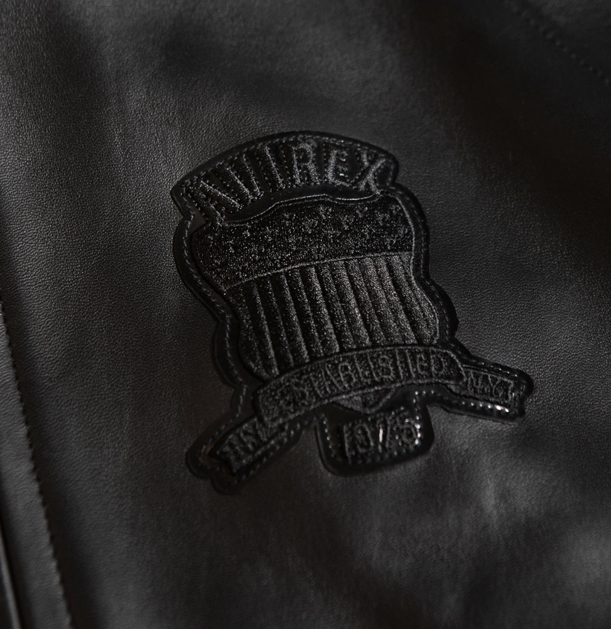 Dark metallic front zipper on black lambskin jacket