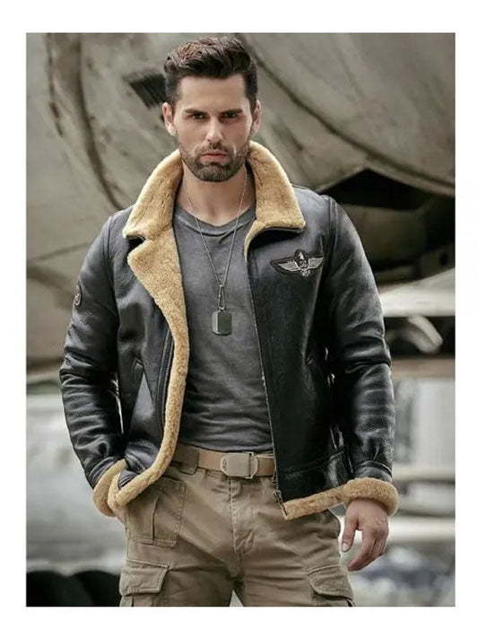 Man wearing a leather jacket with shearling lining in front of an airplane.