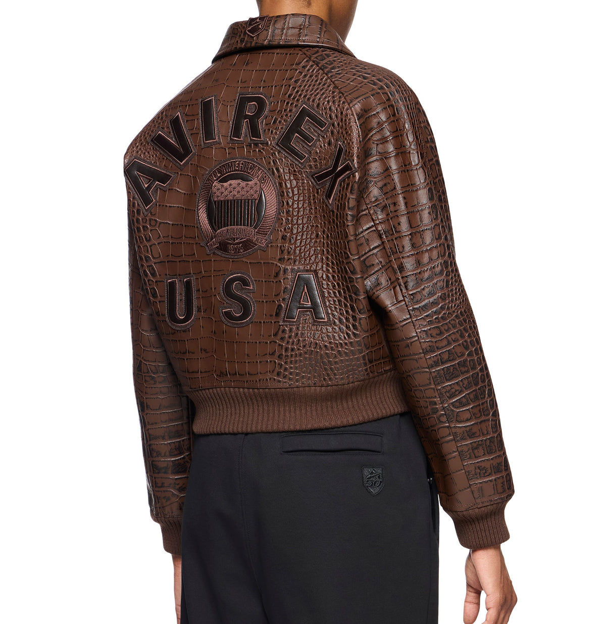 Brown knitted rib cuff on women’s cropped leather bomber jacket