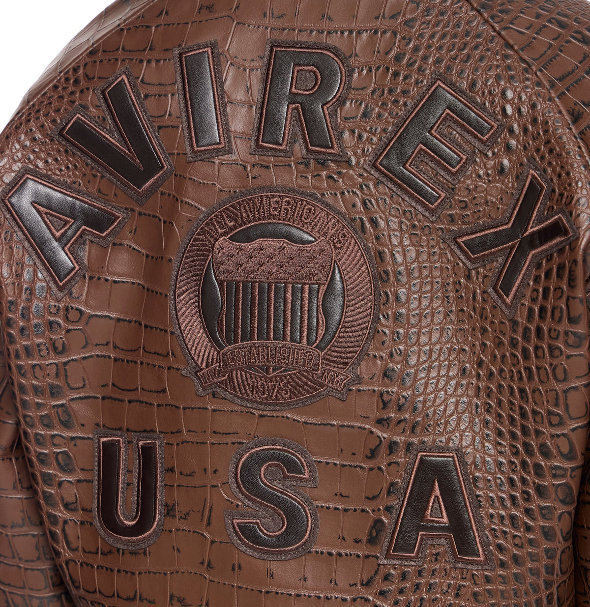 Close-up of tonal AVIREX leather lettering and embroidered back crest